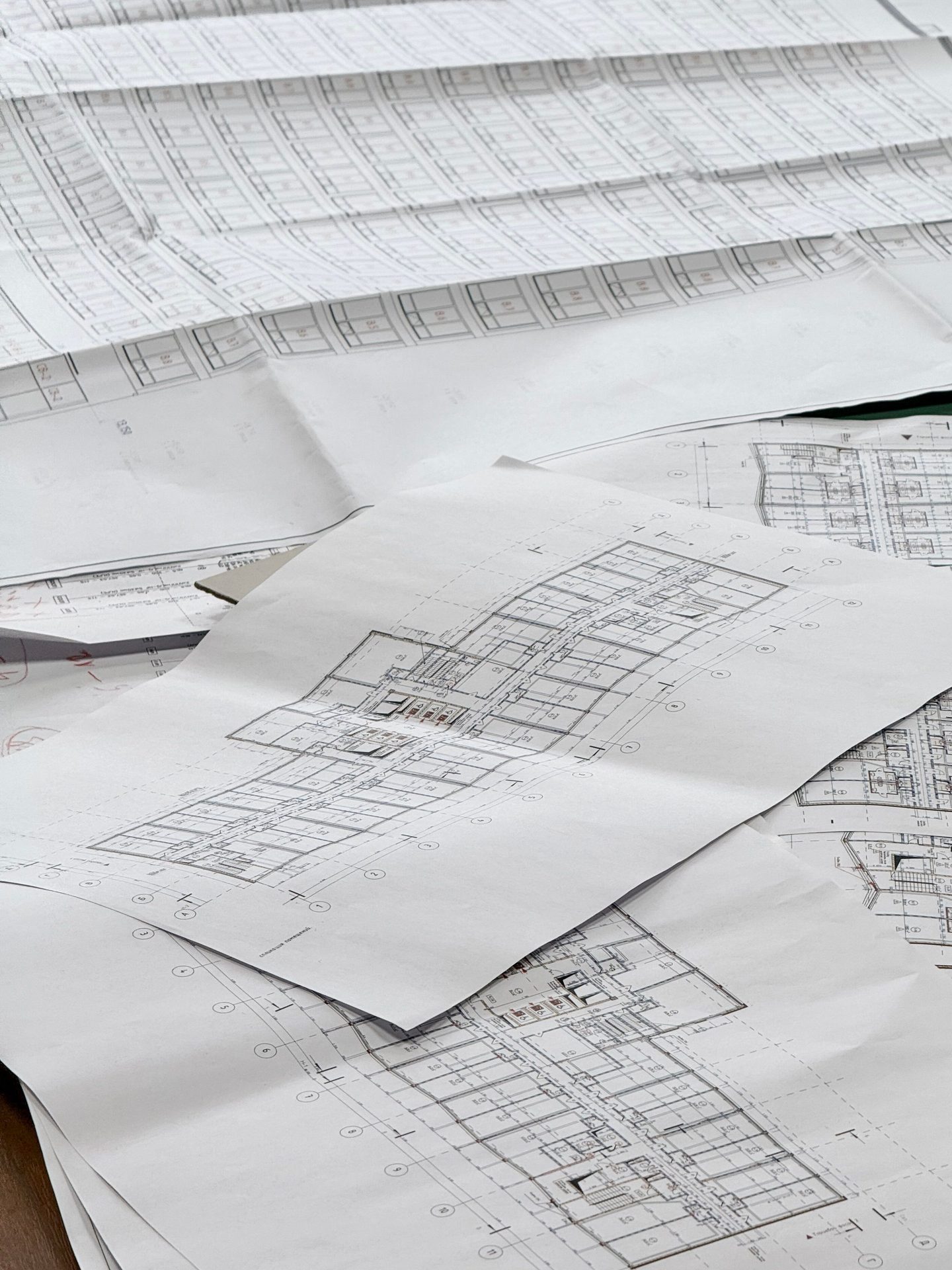 Evaluar proyectos inmobiliarios: planos arquitectónicos detallados sobre un escritorio
